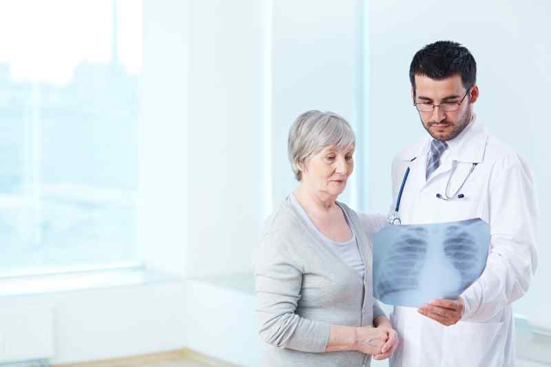Doctor Showing X Ray Elderly Patient