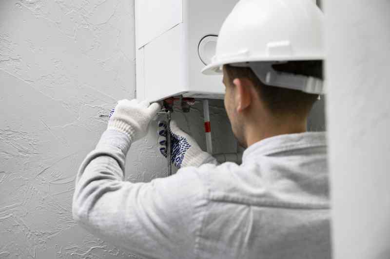 Worker Repairing Water Heater 2